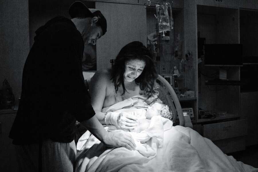 A mom and dad cry over the body of their stillborn daughter at the hospital