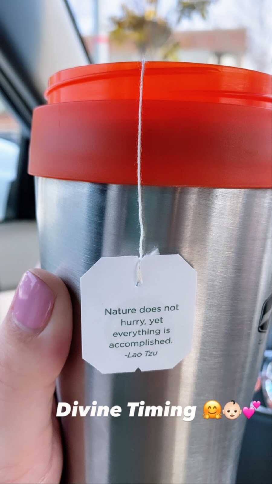 A mom holds a steel mug with a message reading 'Diving timing'