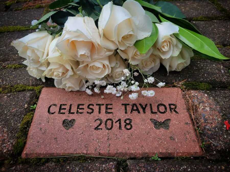 Couple add lost baby's name to brick pathway at park.