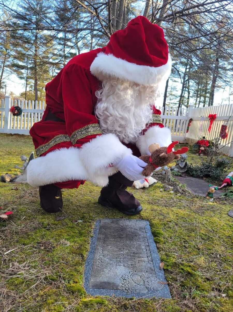 Santa visits cemetery to leave gift at graves of babies.