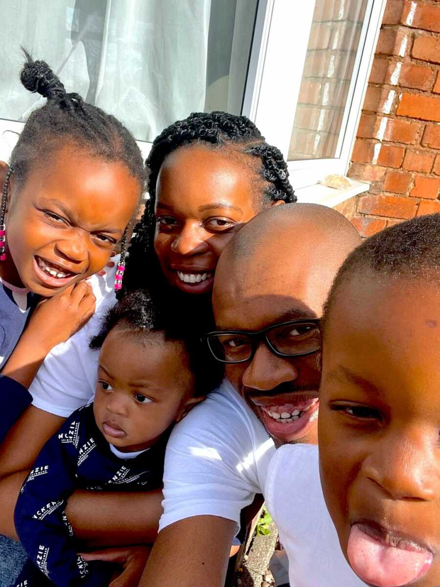 Family of five take a group selfie together while enjoying some sun