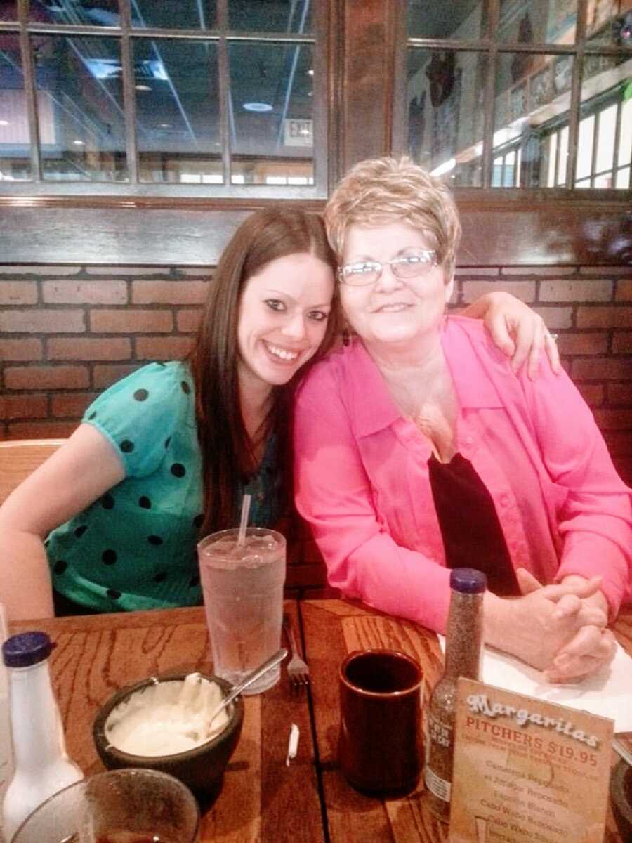 A woman sits with her grandmother at a restaurant