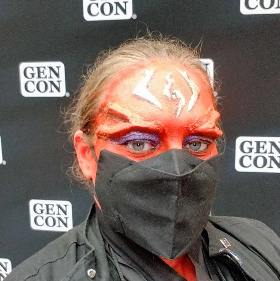 A woman with chronic illness cosplaying as a Sith at a convention