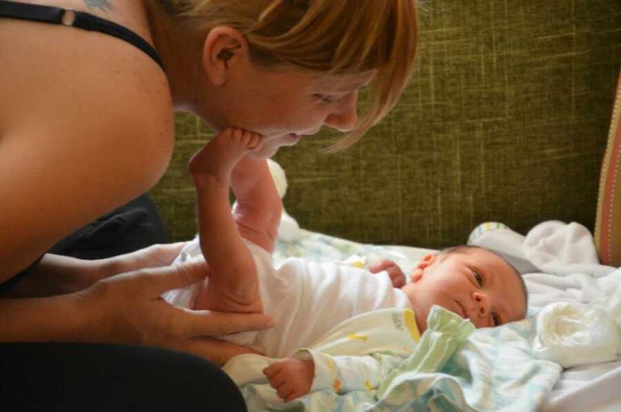 mother changing her newborn baby