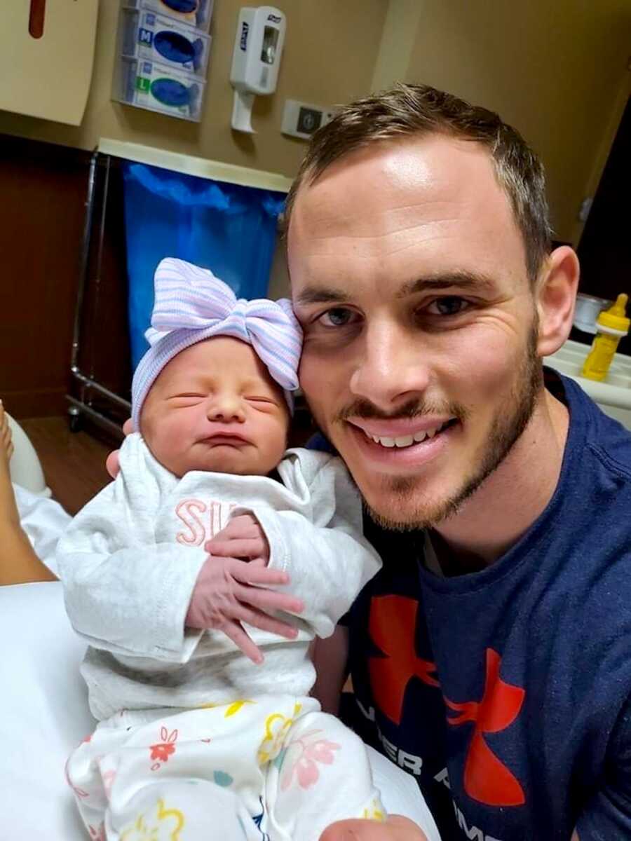Father takes a selfie with his newborn daughter in the hospital