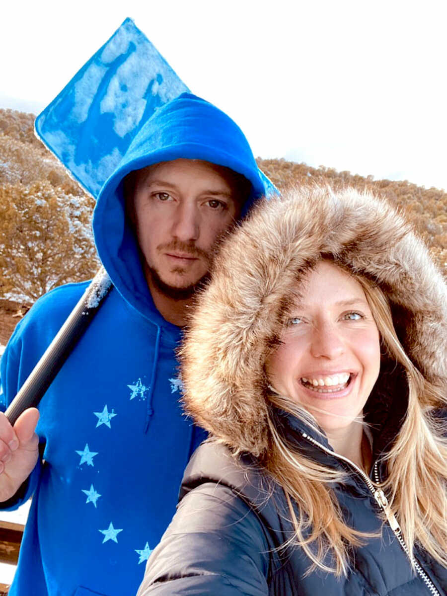 Couple stands together and takes a selfie