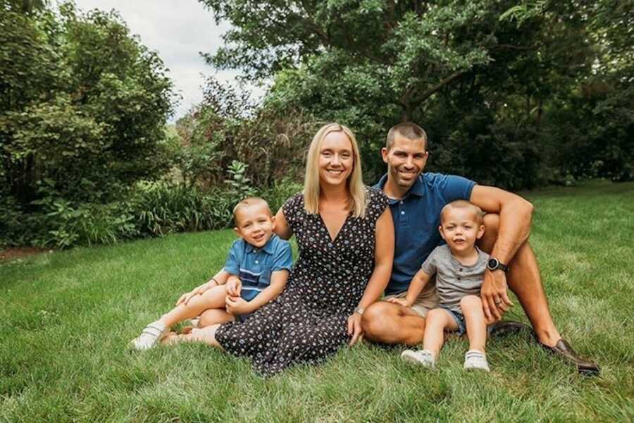 parents sit with their two children