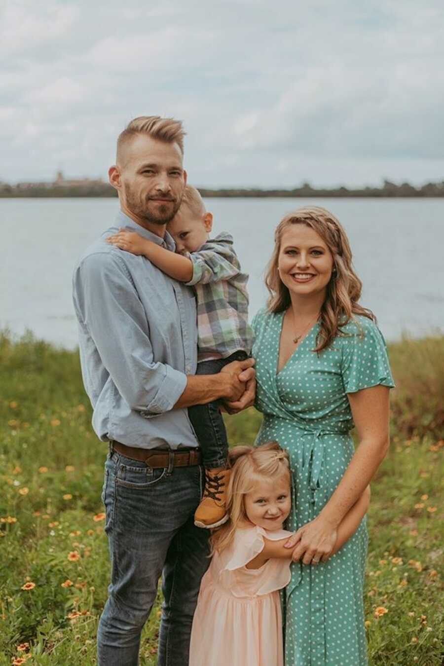 parents stand with their two children