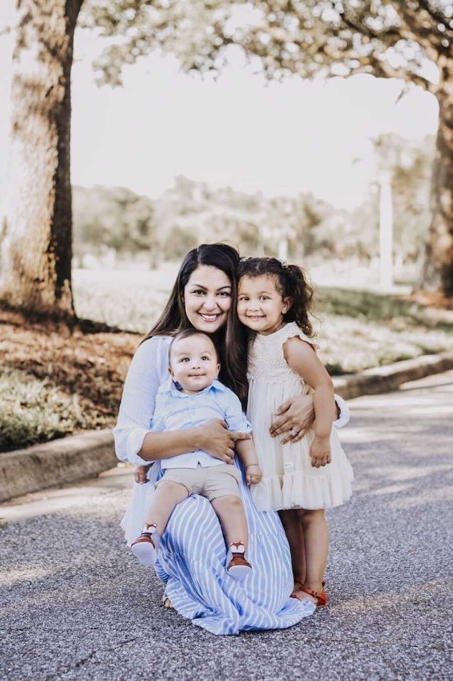 mom stands with her two children