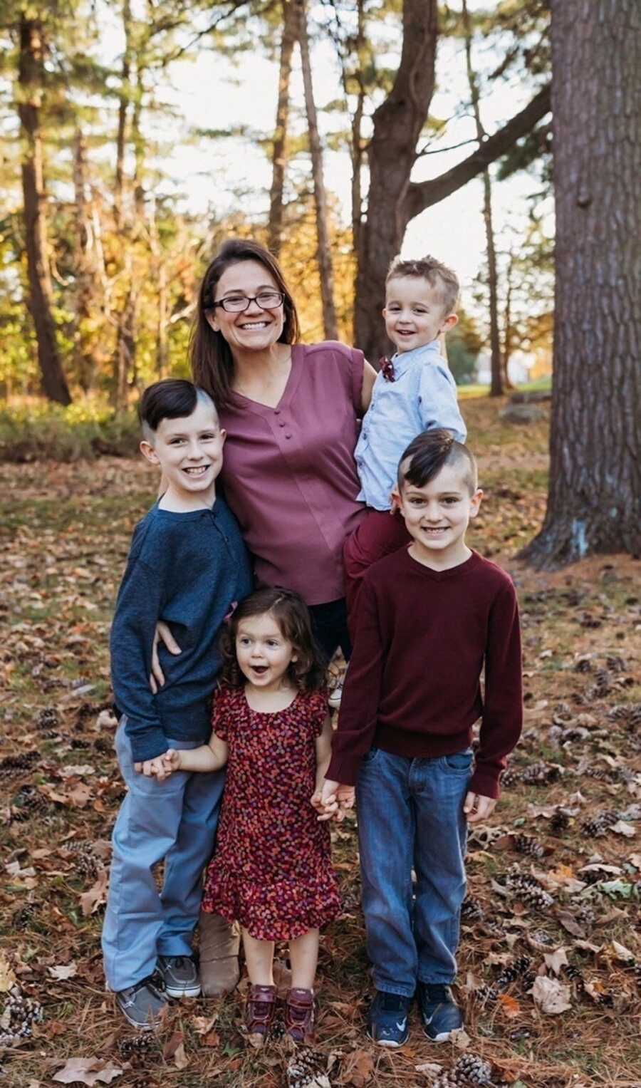 Mom stands with her 4 children