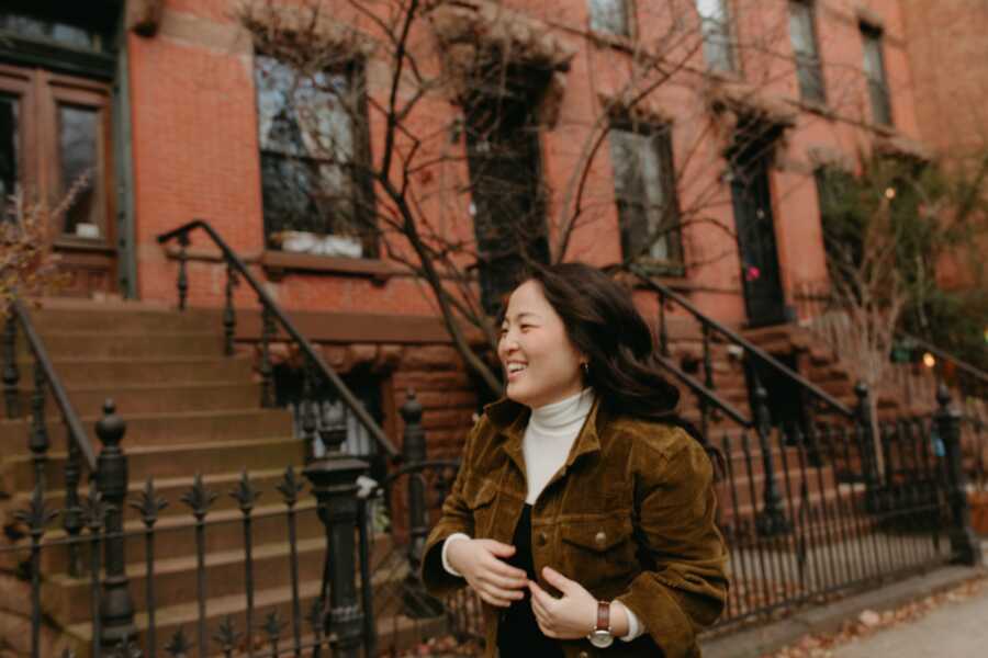 An Asian American woman walking alone through the streets of Brooklyn
