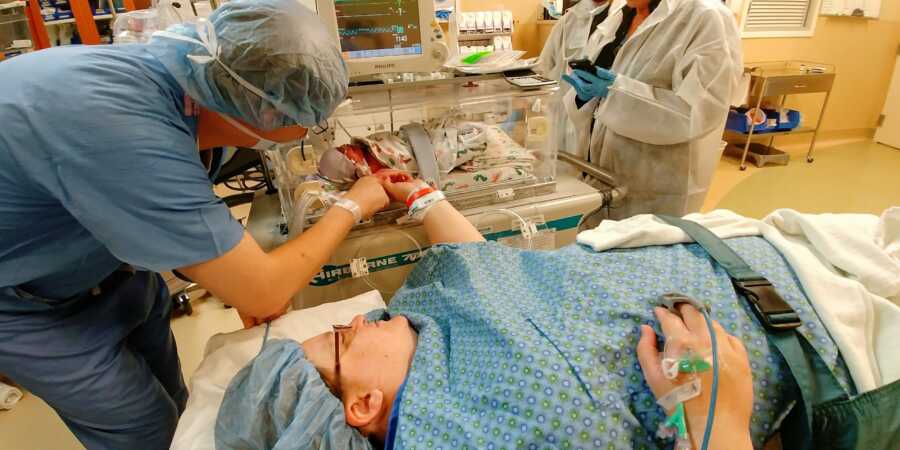 A mom in the hospital visits her newborn baby in the NICU