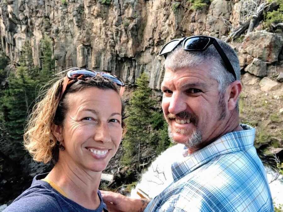 A husband and wife together on a hiking trip