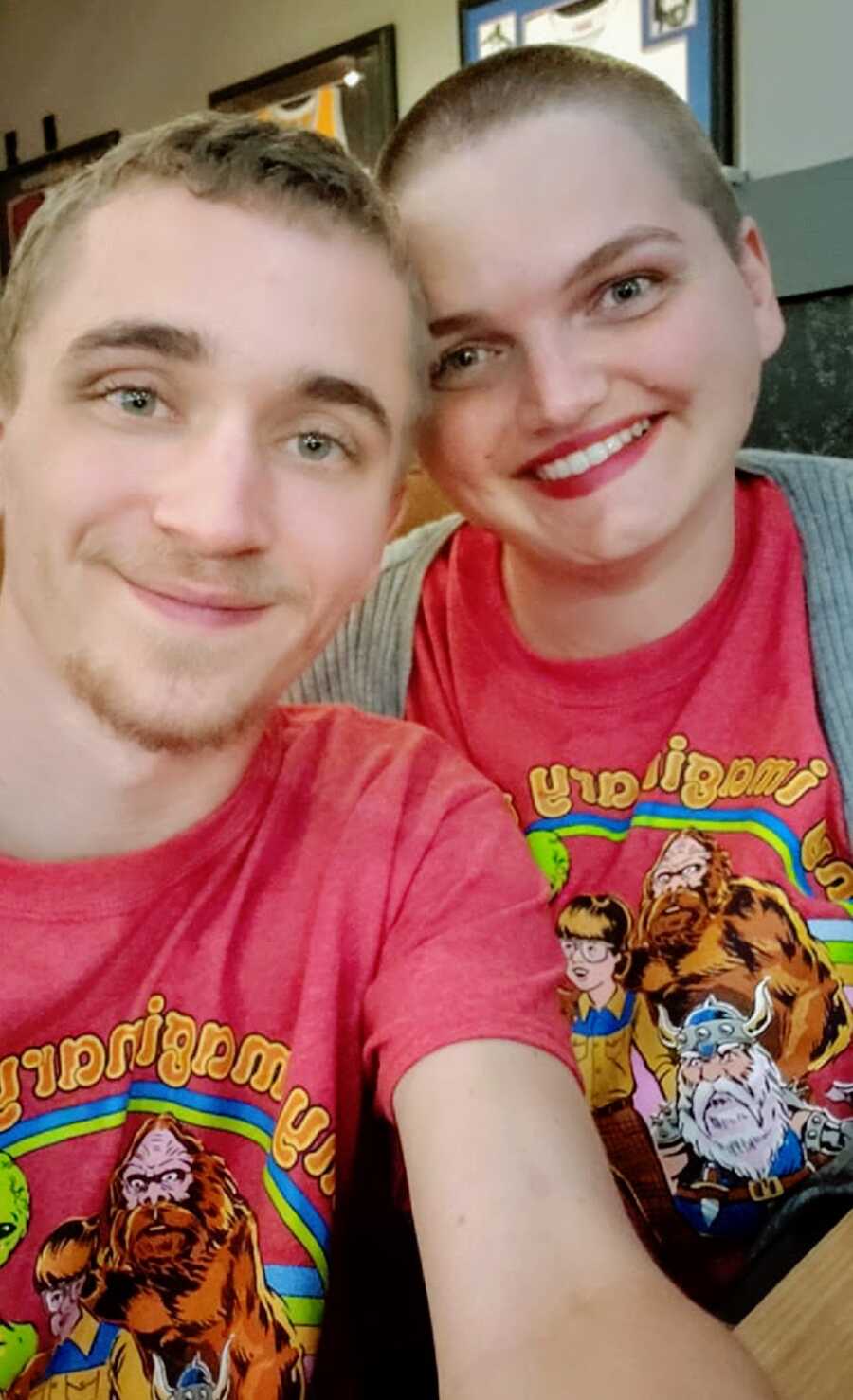 A woman and her partner wearing matching red shirts