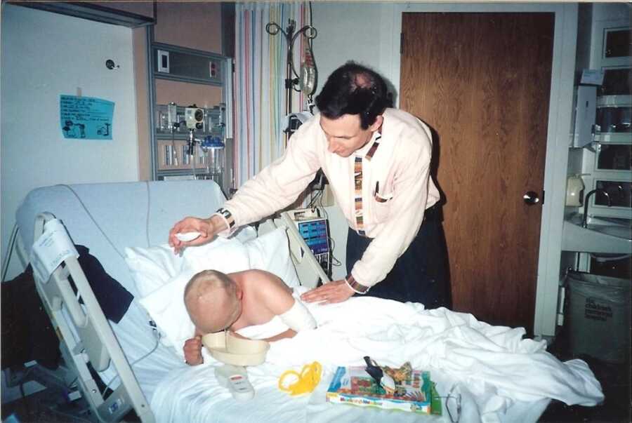 young boy in the hospital battling childhood cancer while doctor checks him