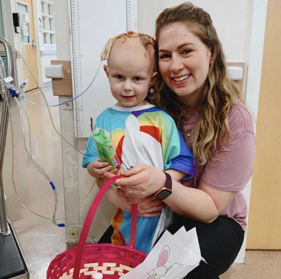 woman stands with child in hospital gown gifted from her nonprofit 