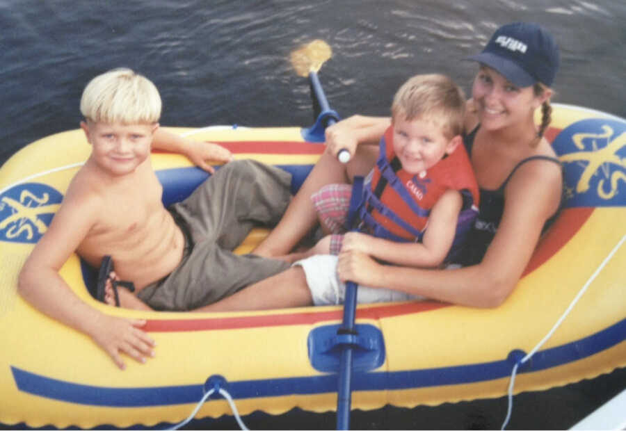 big sister with brother while in raft on the water