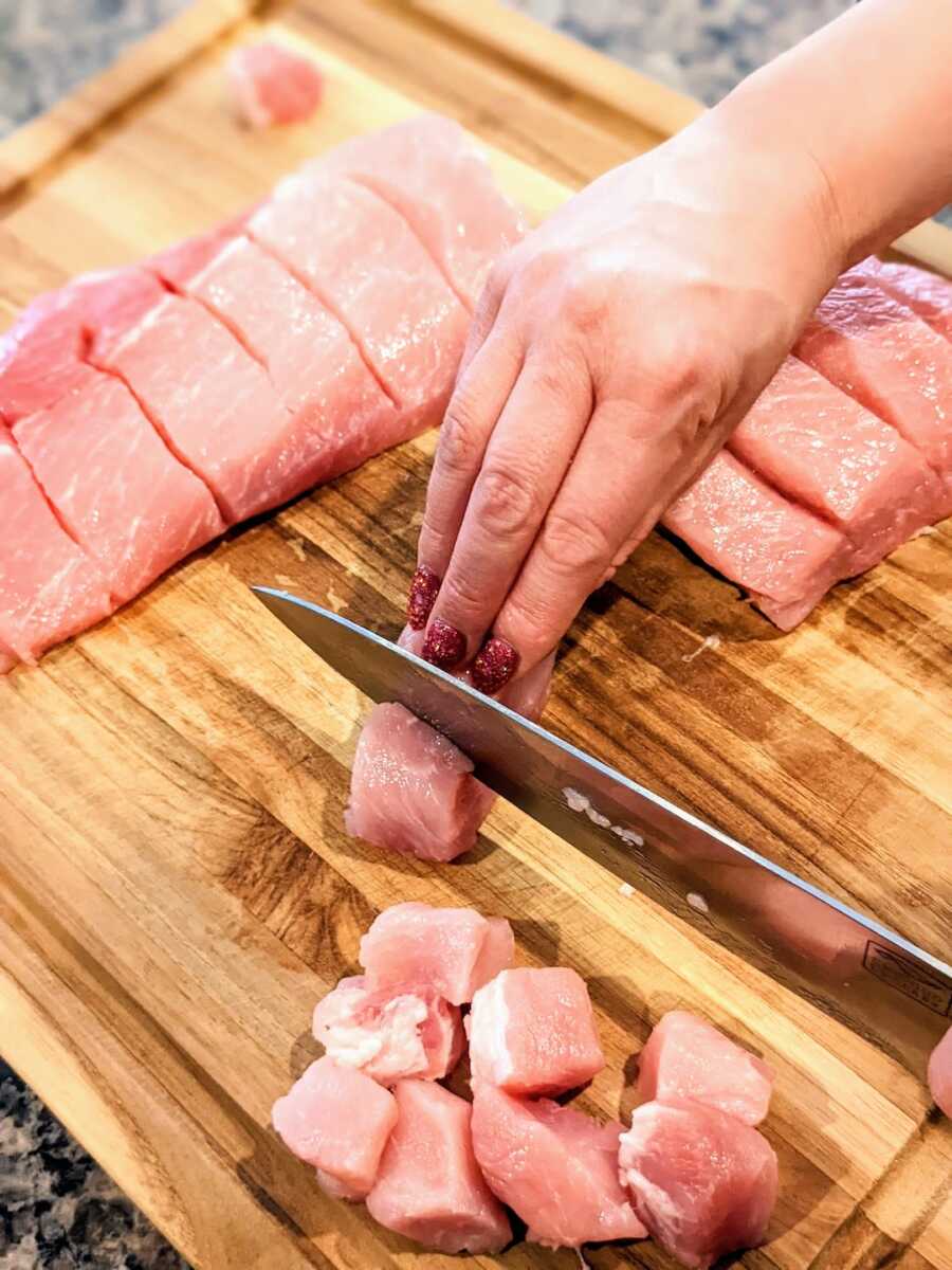 cutting country style pork ribs into bite size pieces