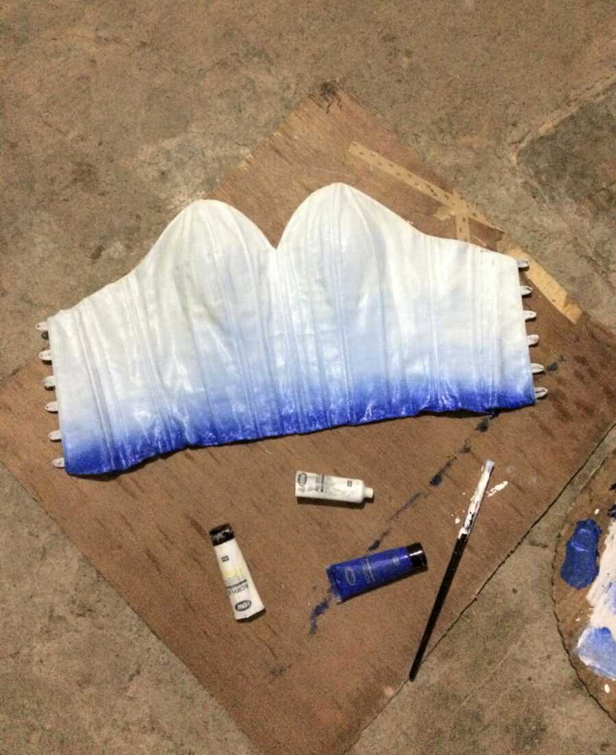 top part of prom dress laid out and being painted to add color