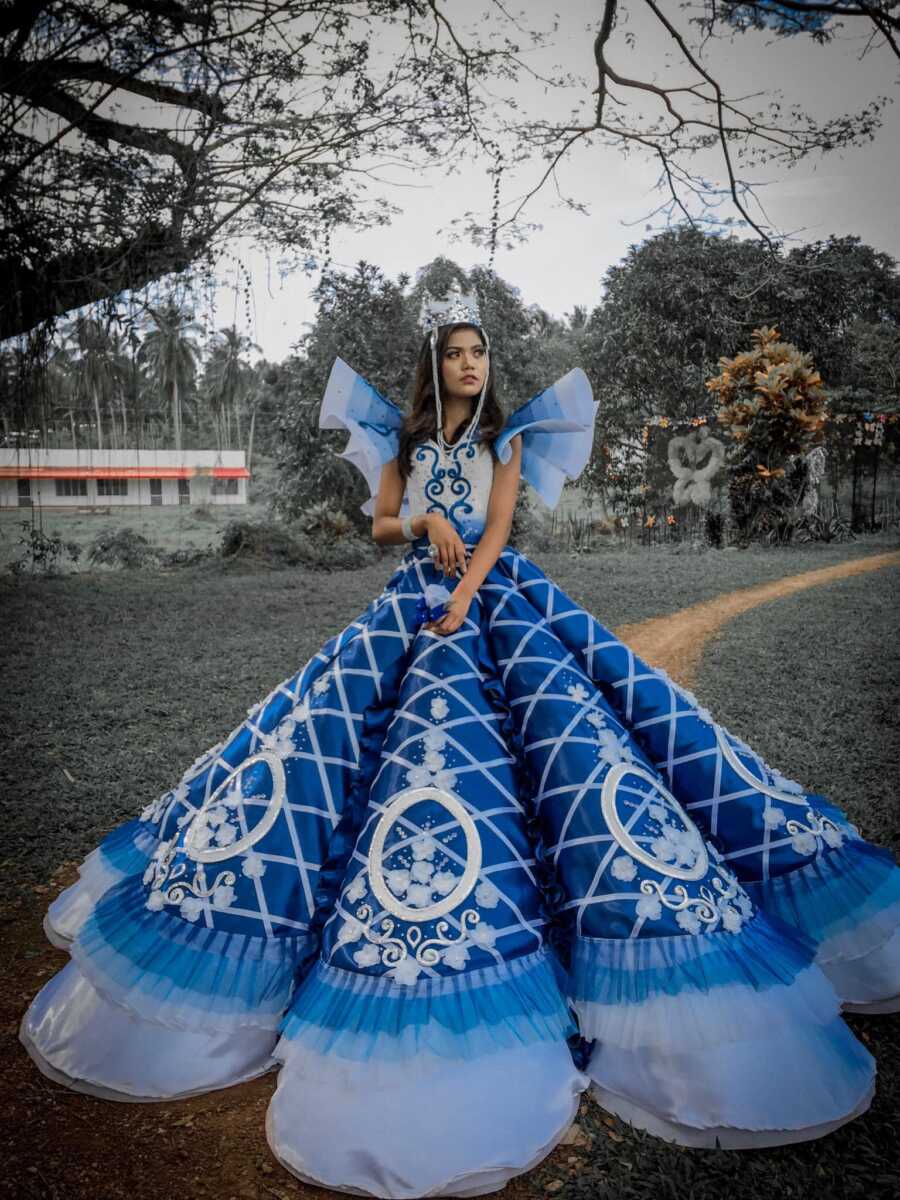 girl poses beautifully in her prom dress made by her brother