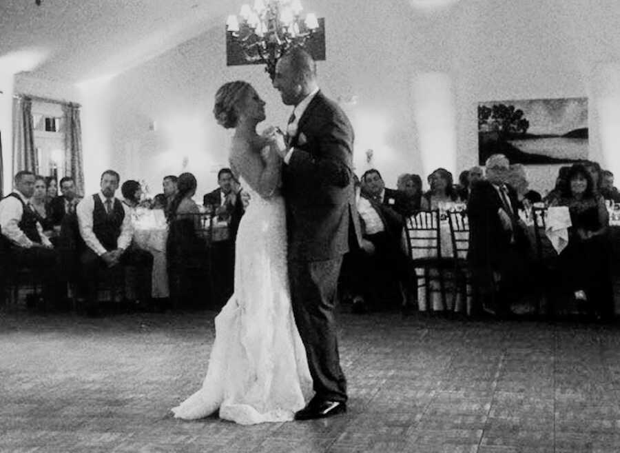 husband and wife dance together on their wedding day