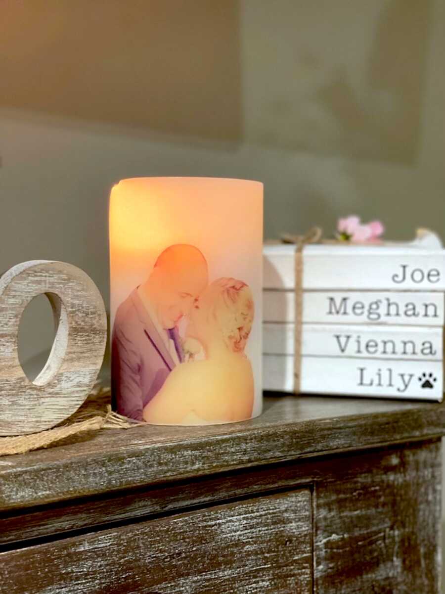 Mantle with candle with a picture of husband and wife printed on it