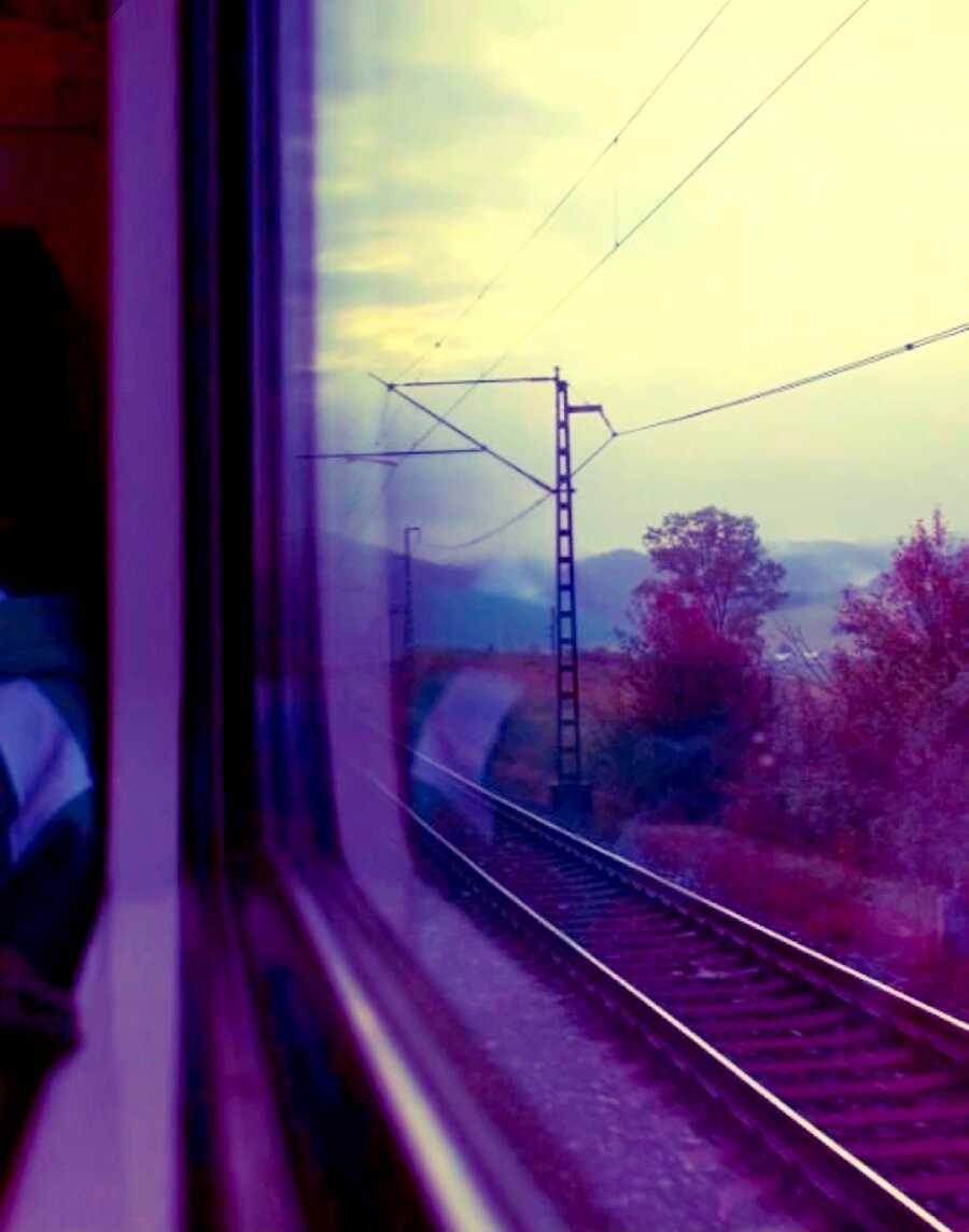 view out train window, scenery passing by