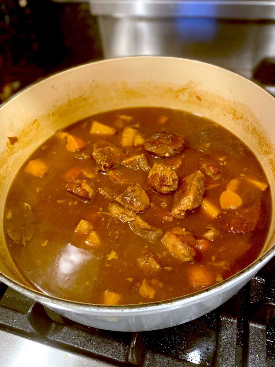Completed adobo recipe sits in pot on the stove