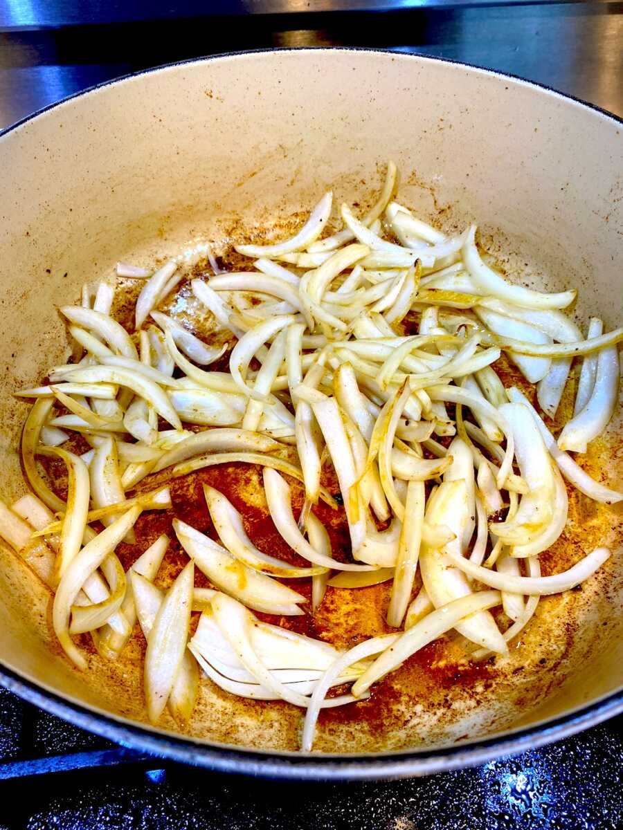 Adding onion into pot after pork has been browned