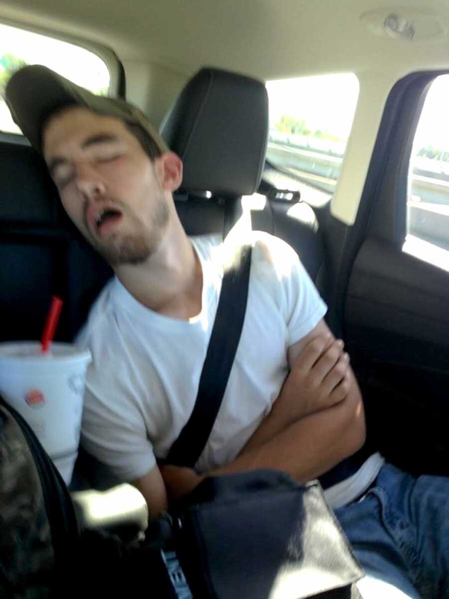 opioid addict sitting in the back of a car passed out