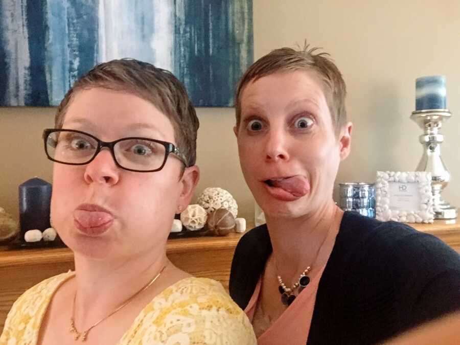 A pair of women sticking their tongues out