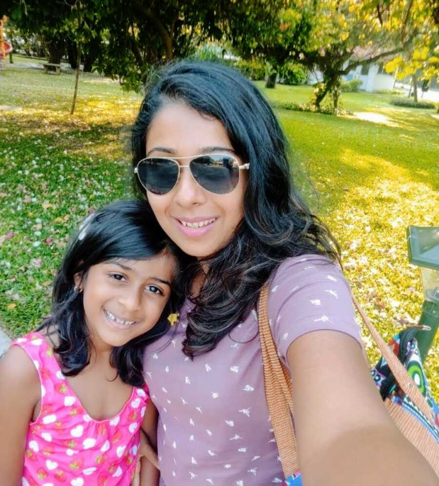 A mom and her daughter together at a park