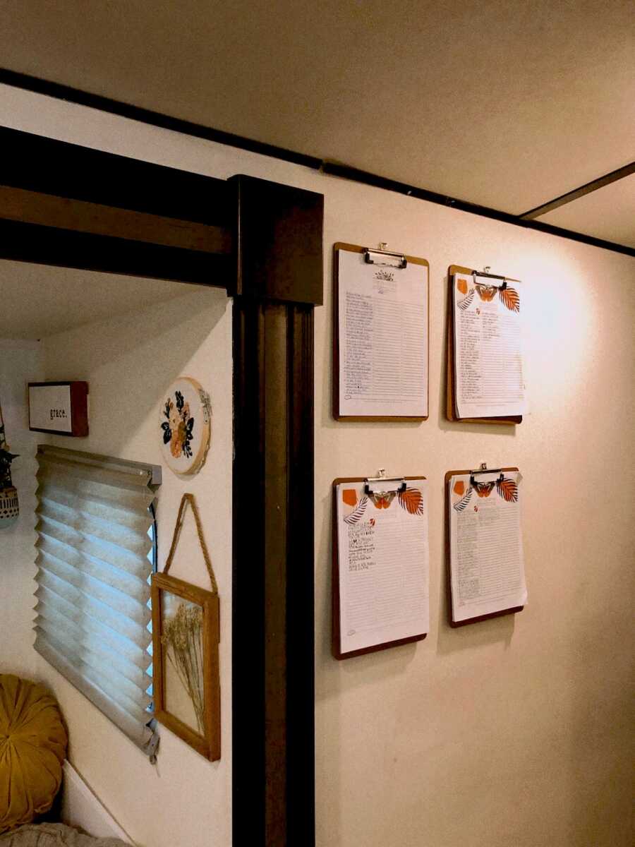 wall with clipboards on it with yearly intentions written down