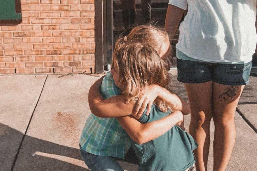 Birth daughter meets and hugs half sister for the first time. 