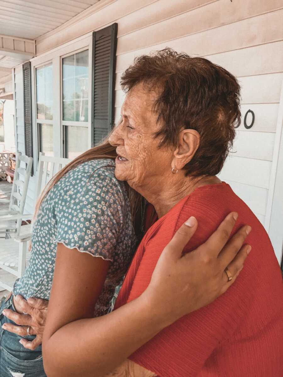 Birth daughter hugs and meets biological great grandmother. 