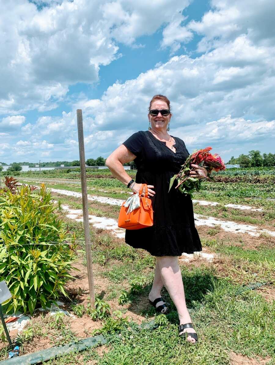 A woman stands outdoors along her weight loss, mental health journey