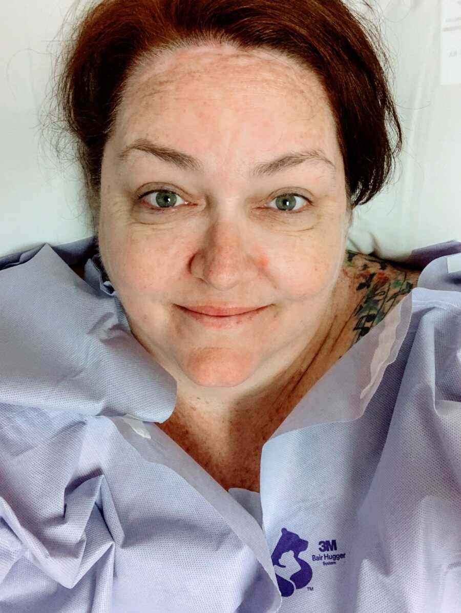 A woman lying in a hospital bed after bariatric surgery