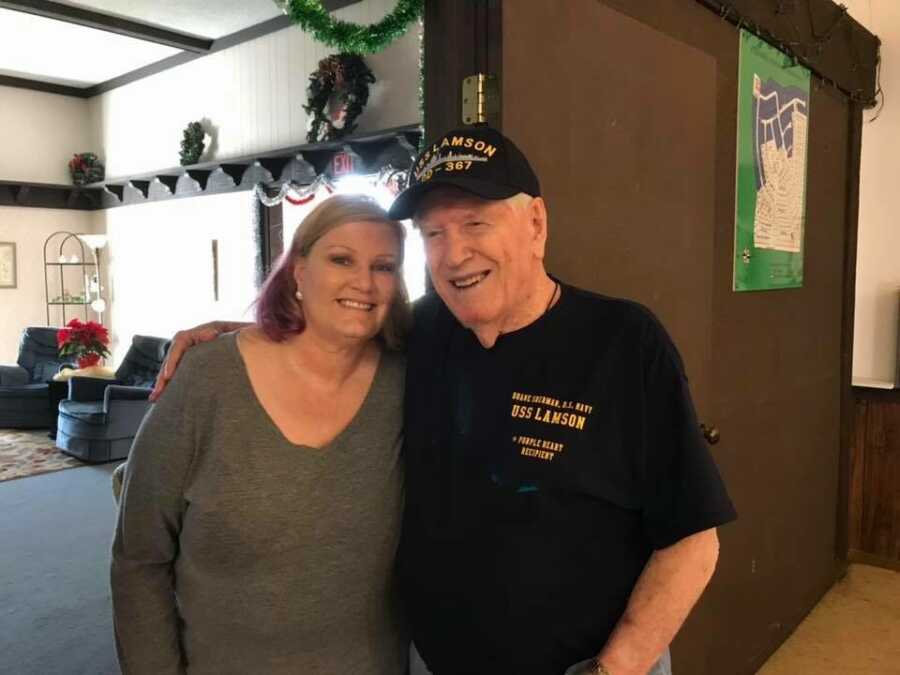 Daughter takes picture with veteran father at special 96th birthday party. 