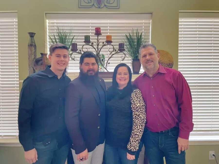 family standing together in living room