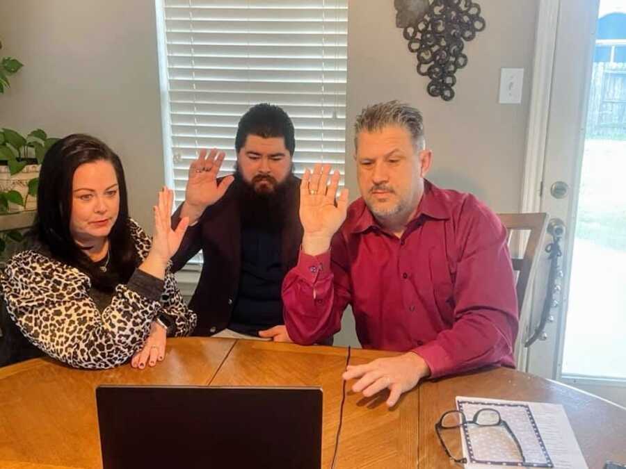 parents with son being sworn in for adoption