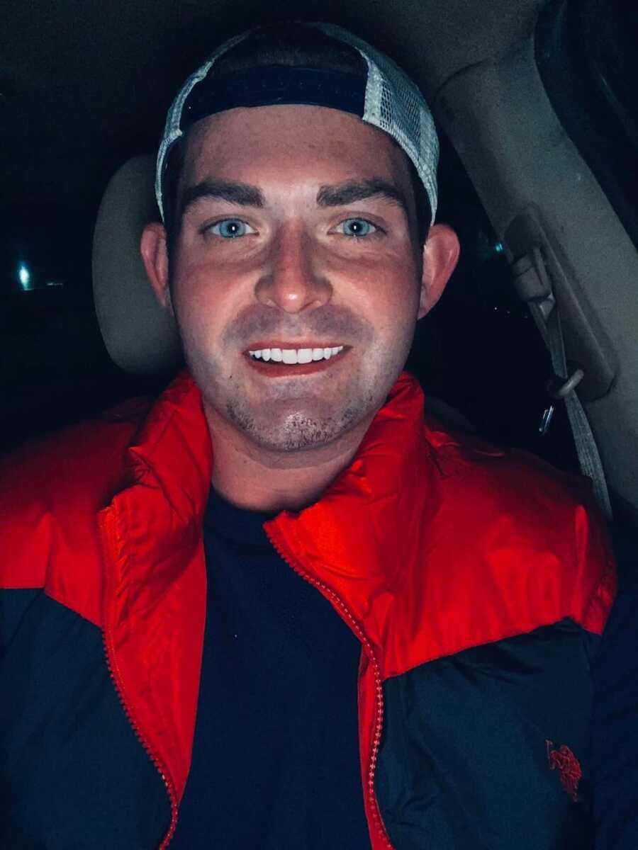 Man smiling in car