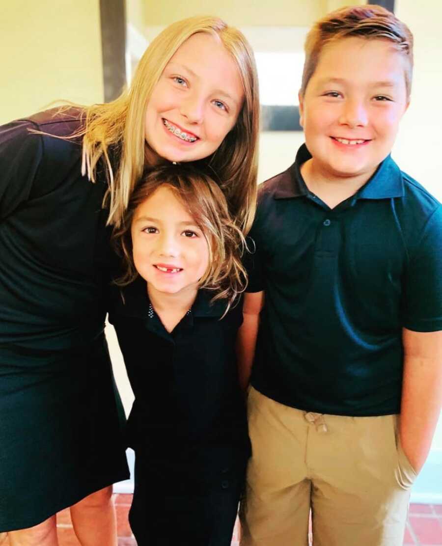 three kids dressed nicely and smiling