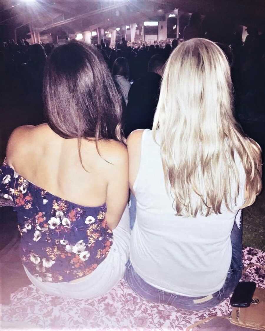 friends sitting together at a concert