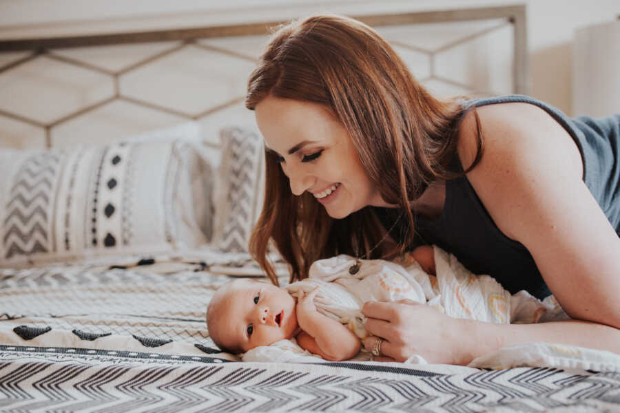 woman playing with her new born