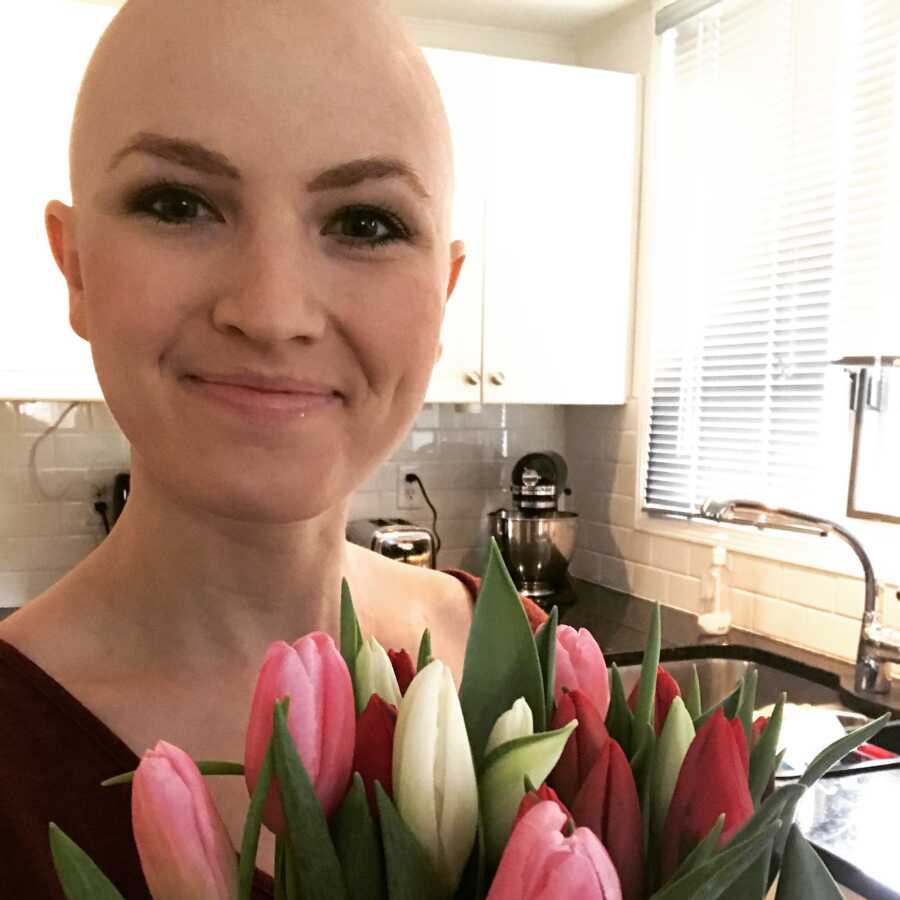 woman receiving flowers after surgery