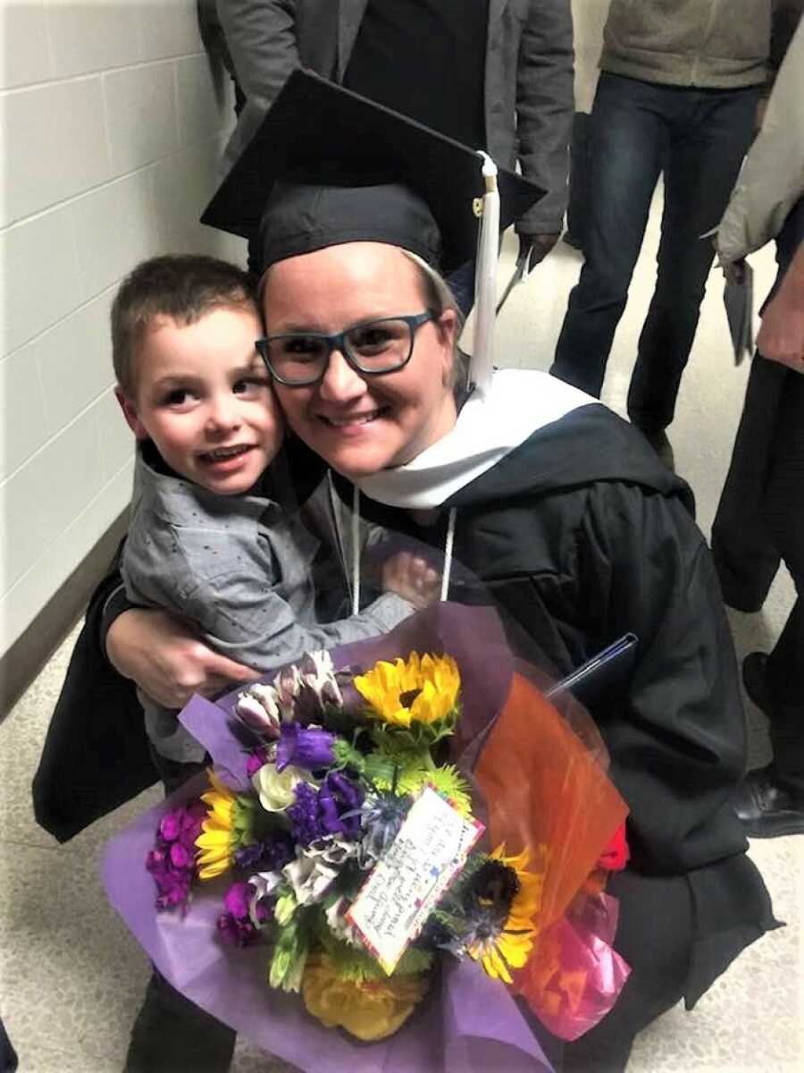 mom holding her son close during her graduation