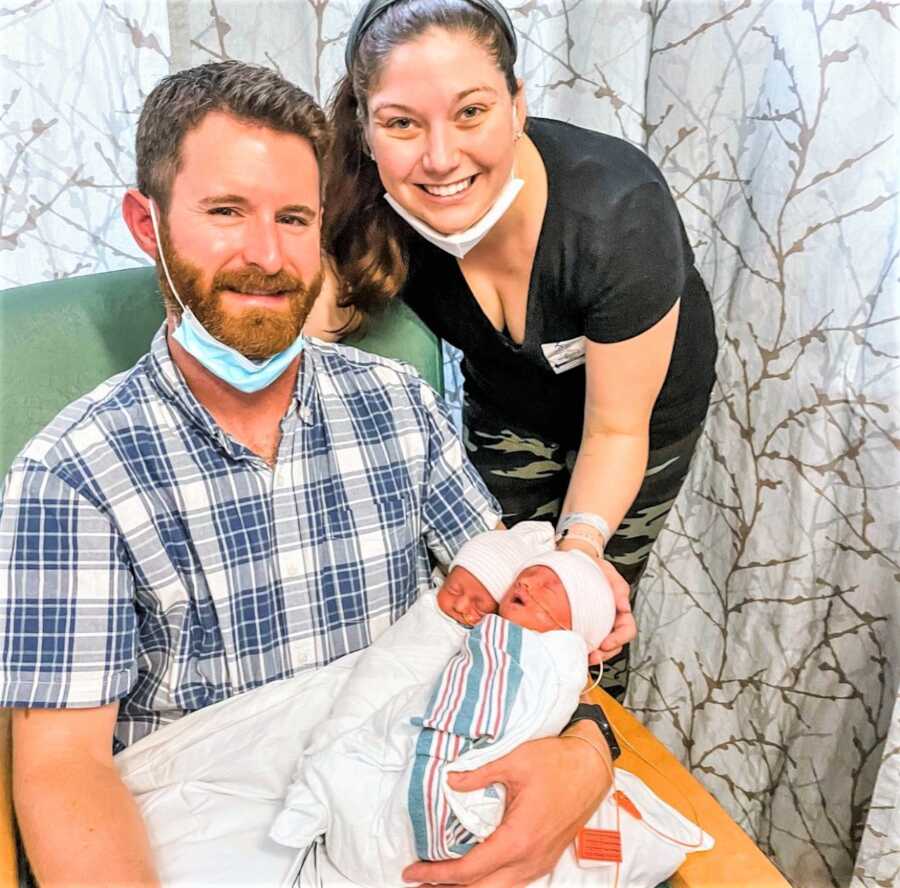 Mom and dad holding their newborn twin girls at the NICU