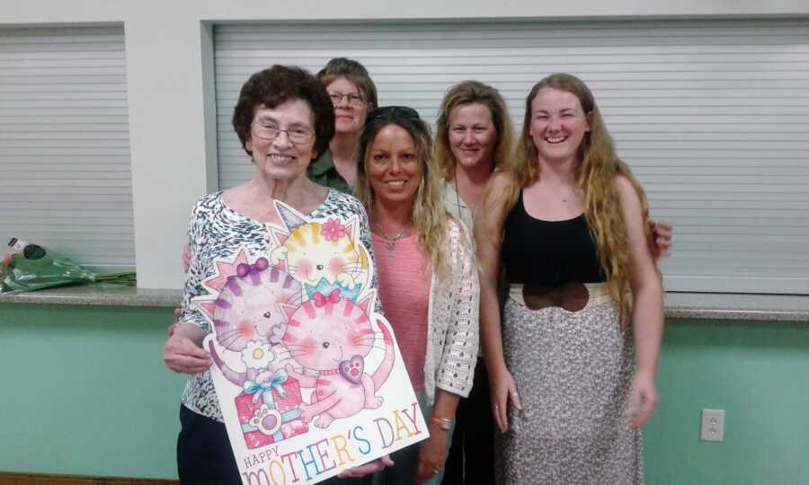 Three generations of women take a photo together at a Mother's Day church banquet