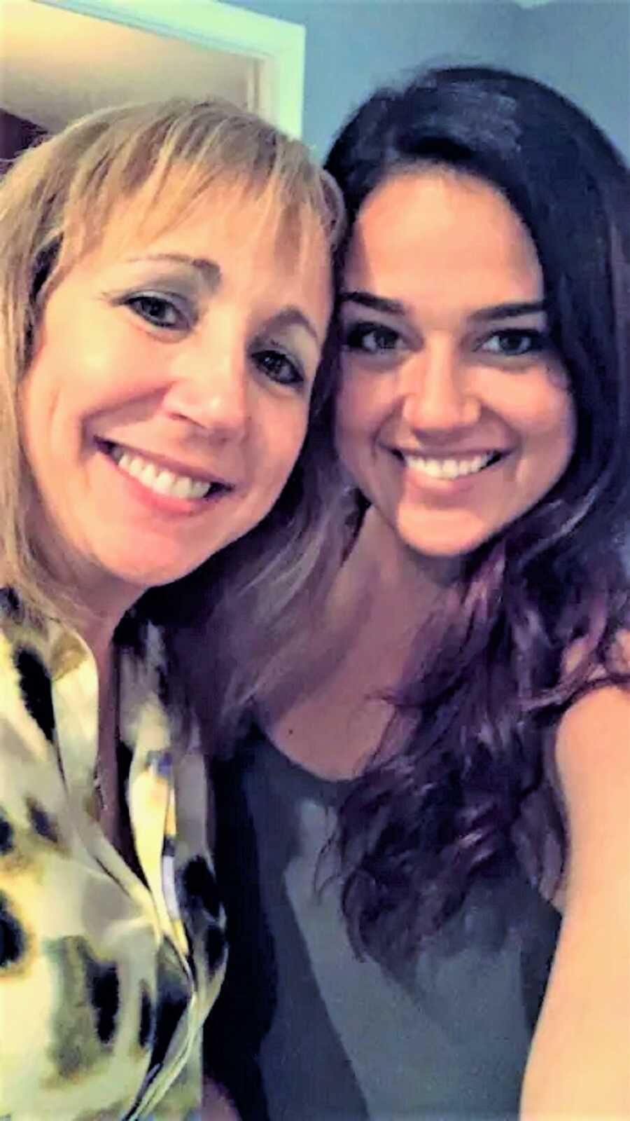 selfie of mother and daughter smiling close together 