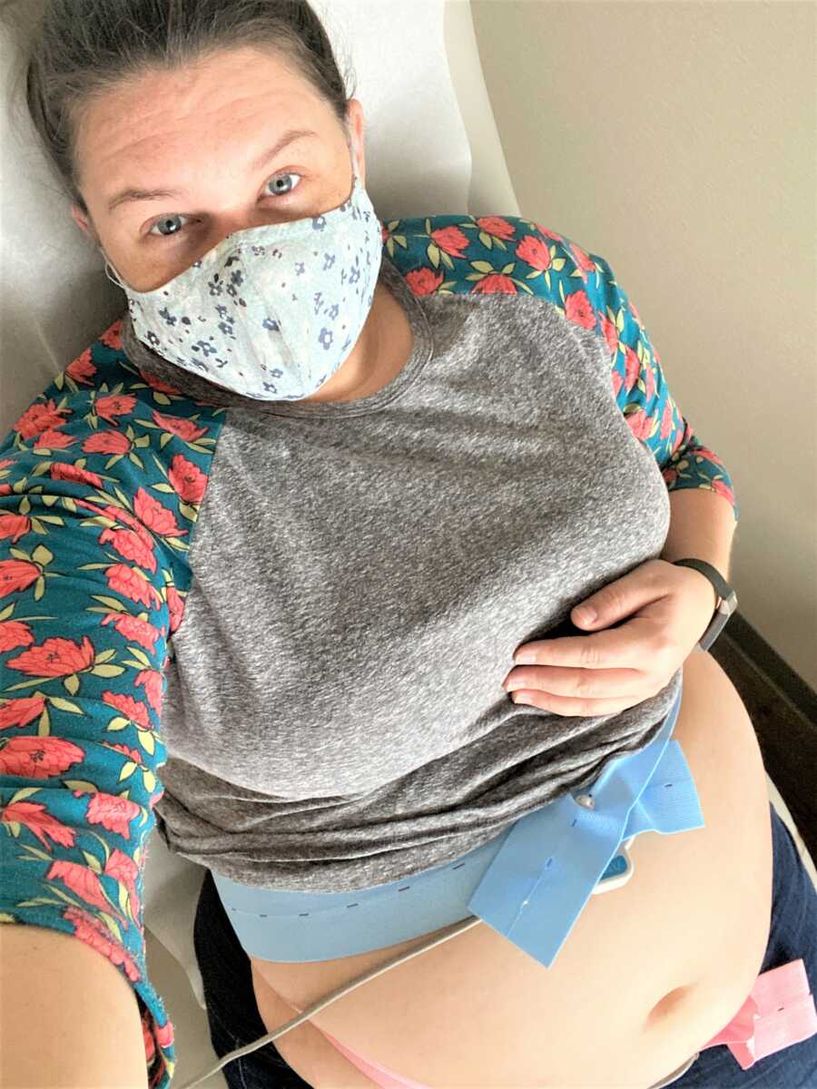 selfie pregnant woman wearing a mask a the doctor with her stomach exposed during an examination 